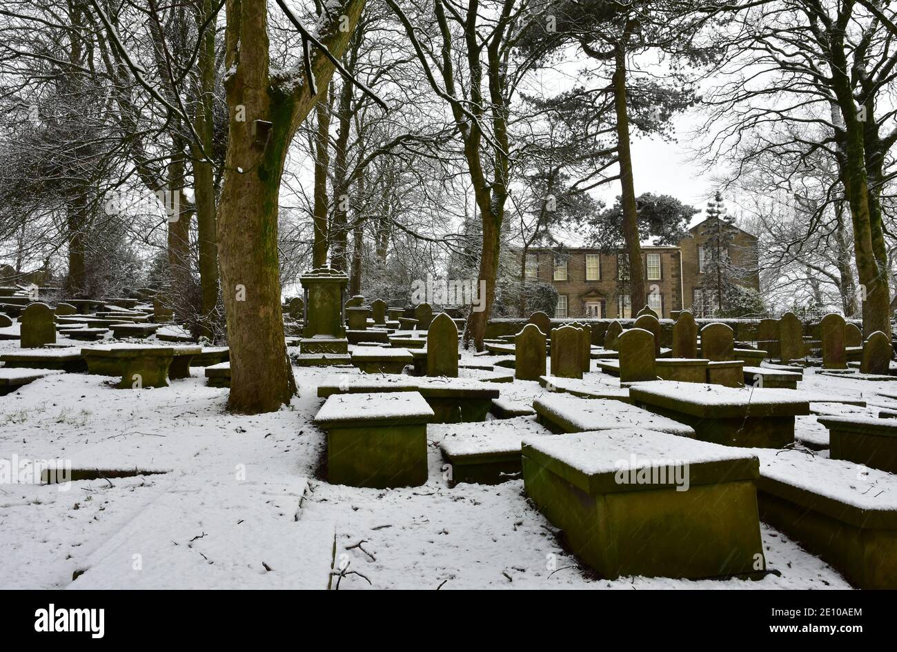 Haworth Bronte Parsonage Museum and graveyard in snow, during Winter ...