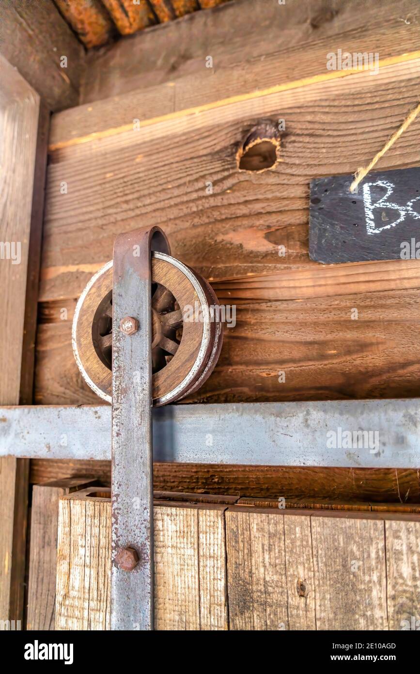 Wooden wheel and metal track of bathroom sliding door with chalkboard