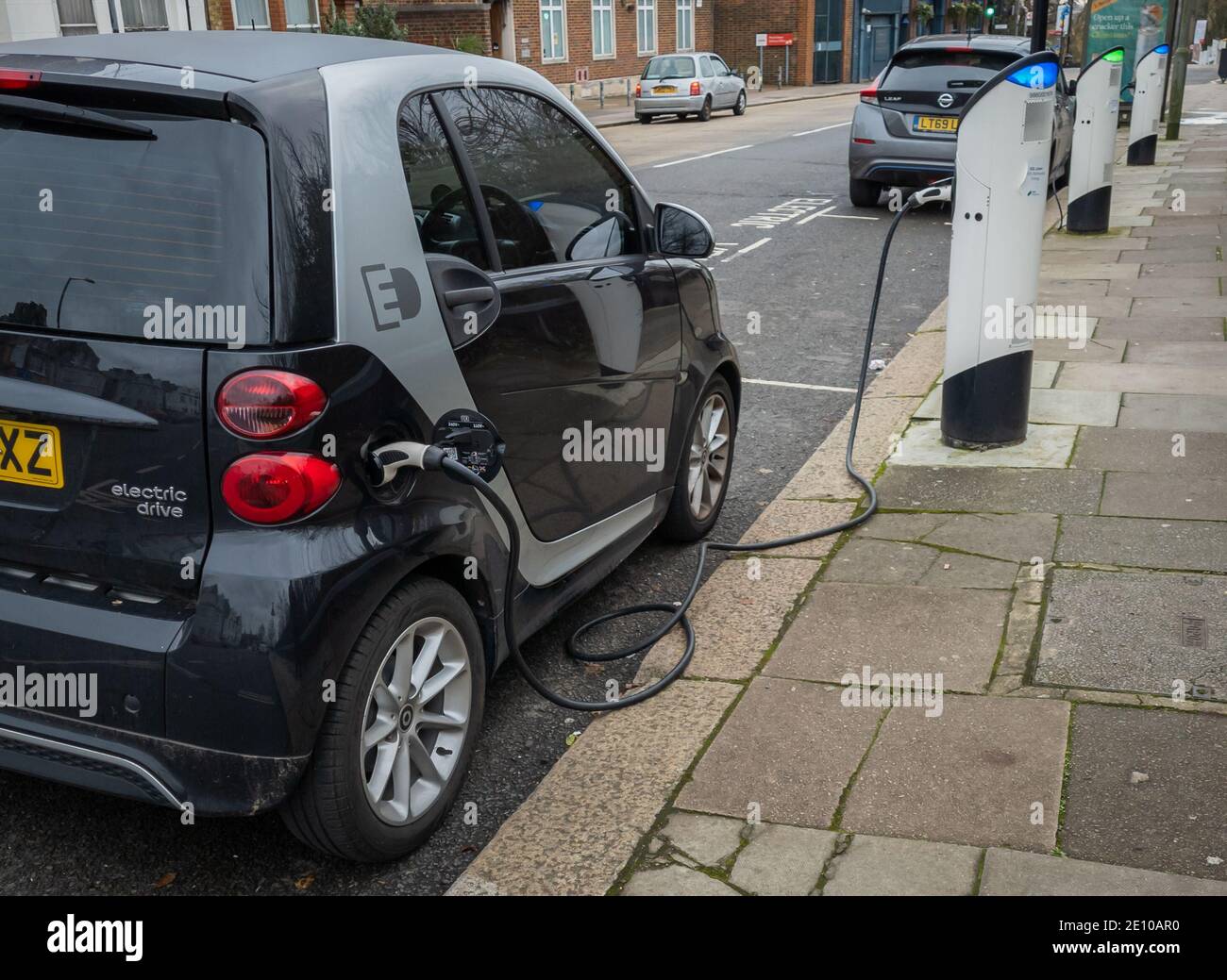 A electric car recharging its batteries in a parking bay with a