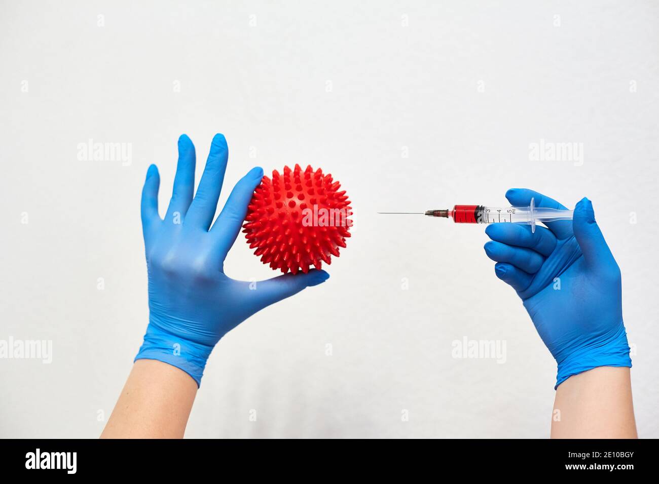 coronavirus vaccine, vaccination of the population against the disease, fighting the epidemic, hands in medical gloves holding a syringe with medicine Stock Photo