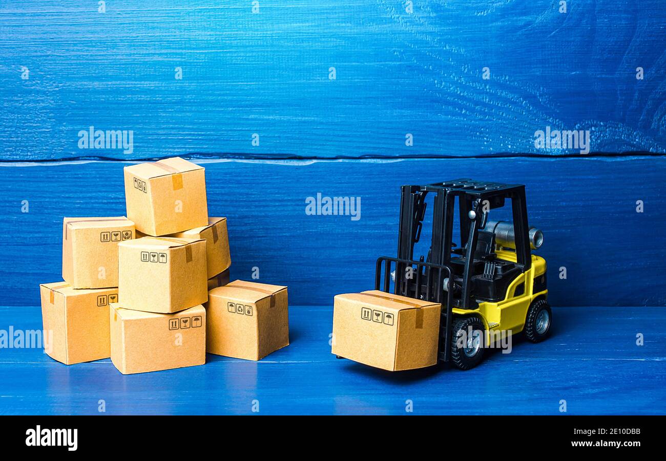 Forklift truck and cardboard boxes with goods. Logistic infrastructure