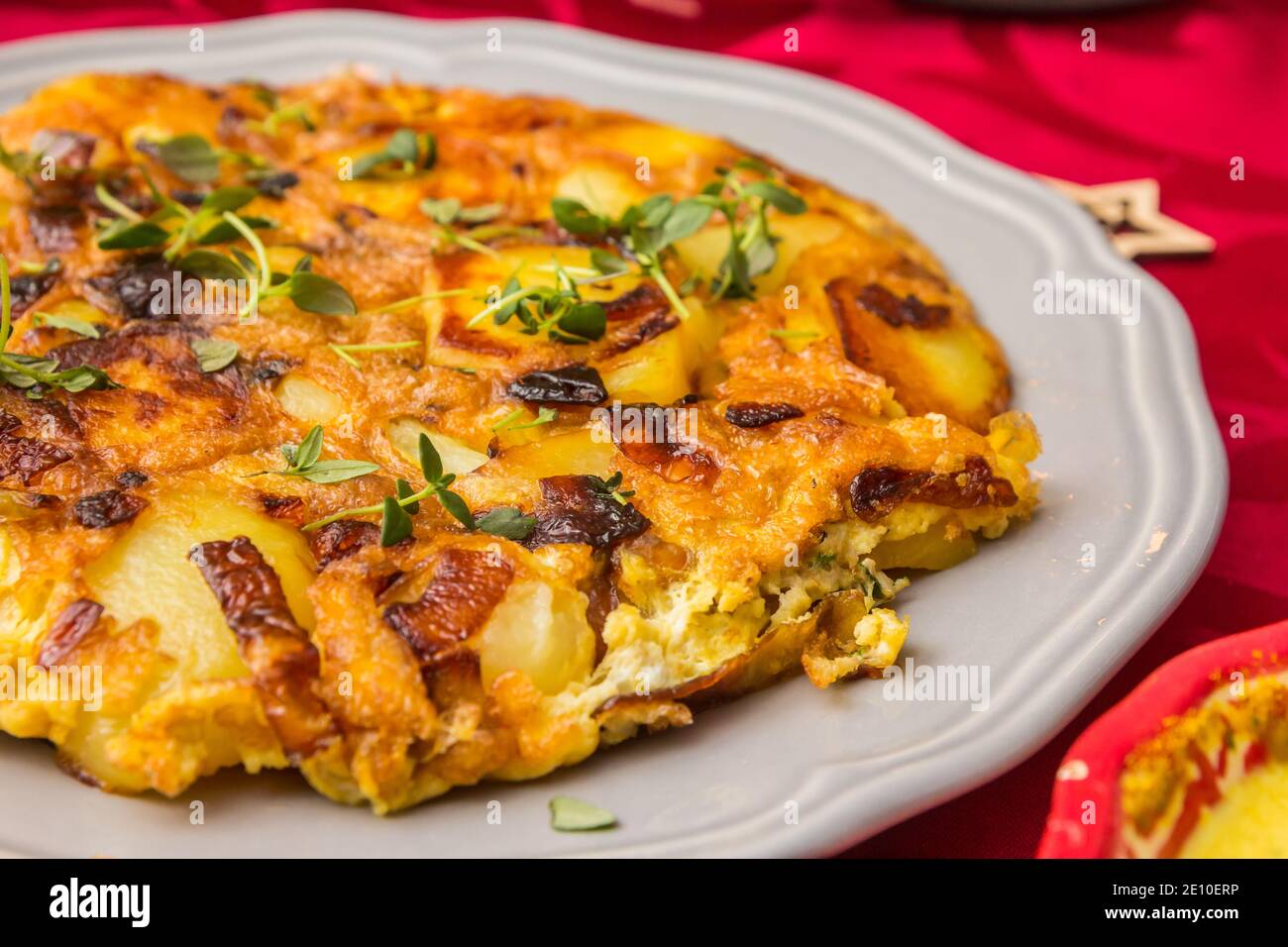 Traditional spanish tortilla with potato, egg and onion on a white