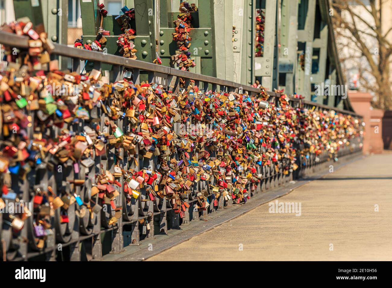 Many locks on the green bridge railing of the iron bridge in Frankfurt over the river Main