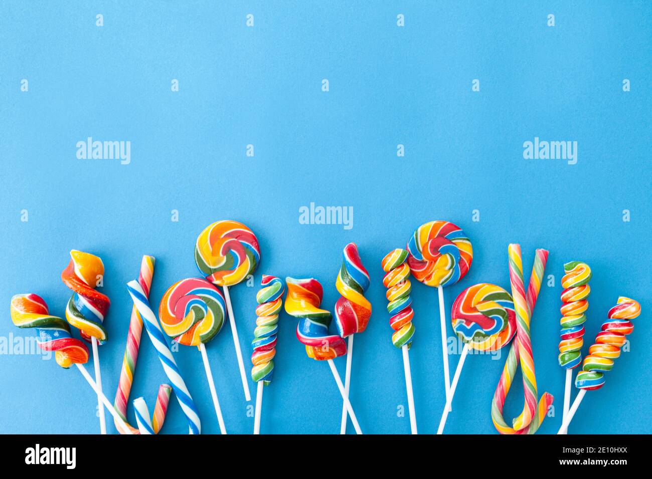 Colorful Sweets On Blue Background Stock Photo - Alamy
