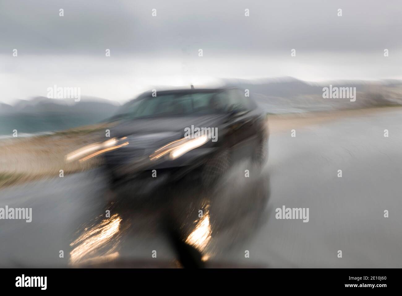 Car on a rain-soaked road Stock Photo