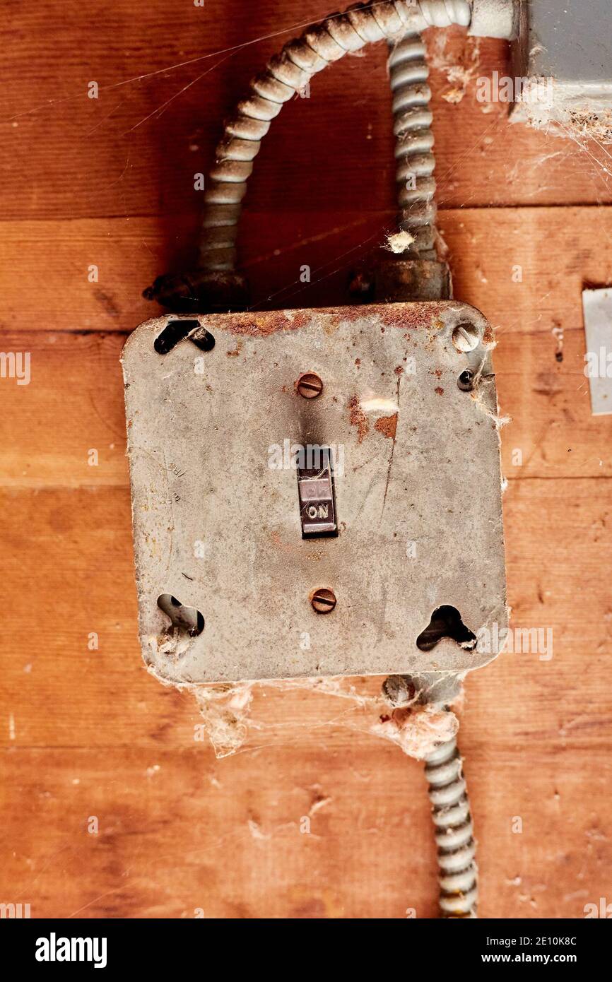 Electrical Switch in in On Mode, Set in Metal Junction Box on Wooden