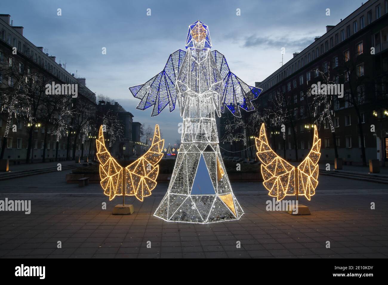 Christmas decoration illuminated angel with pair of wings on empty square in Krakow, Nowa Huta, Poland. Stock Photo