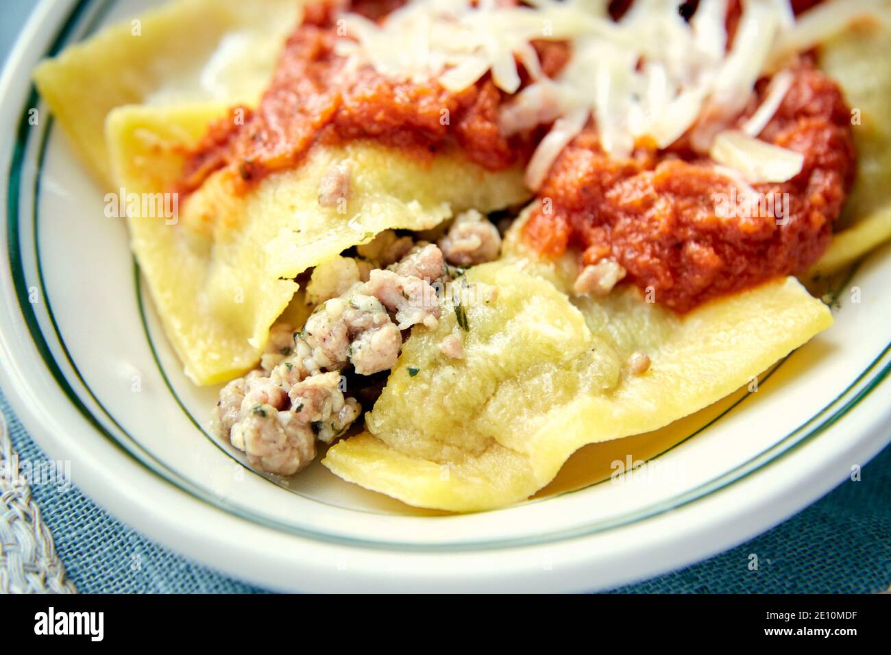 Ravioli with Meat Sauce and Grated Cheese, Closeup on White Plate Stock Photo