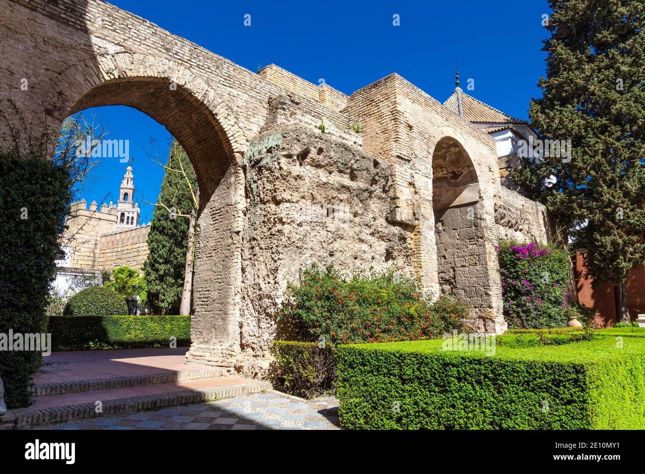 Stone 12th century arches separating Patio de la Montería and Patio del Leon (The Lion Courtyard), Royal Alcázar of Seville, Andalusia, Spain Stock Photo