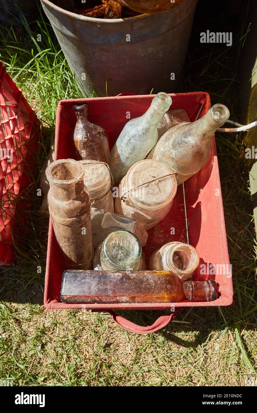 Plastic Crate of Old, Dusty Glass Bottles with Open Mouths Stock Photo