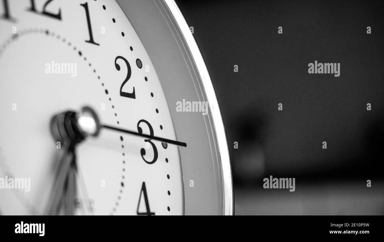 Black white big metallic clock close up. Time or showing time concept. Classic retro mechanical alarm clock with ringer. Time passing or waking up in Stock Photo