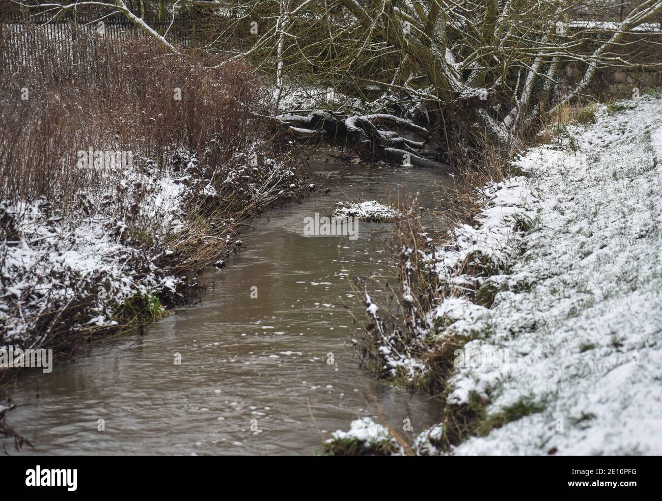 A brook in the park in the snow one afternoon in winter time in Uttoxeter, England Stock Photo