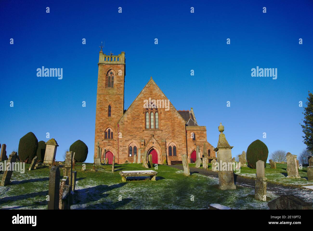 Front view of Earlston Parish Church and graveyard with light snow on the grass, Earlston, Berwickshire, Scottish Borders, Scotland, UK. Stock Photo