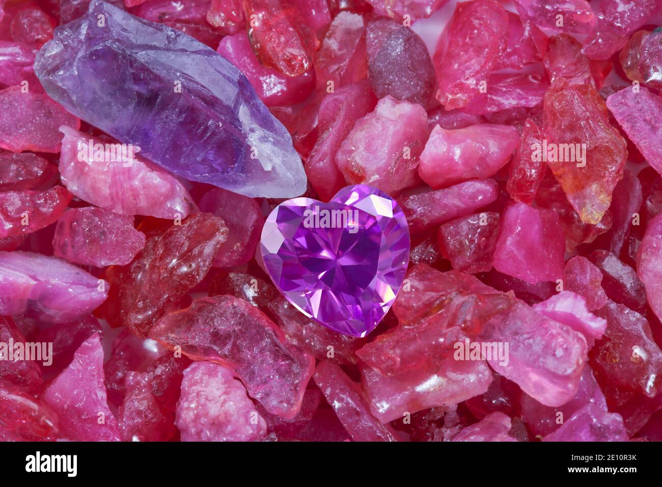 heart amethyst diamonds on raw ruby rough gemstone Stock Photo - Alamy