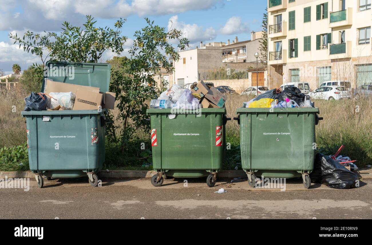 Campos, Spain; january 03 2020 three green trash containers filled