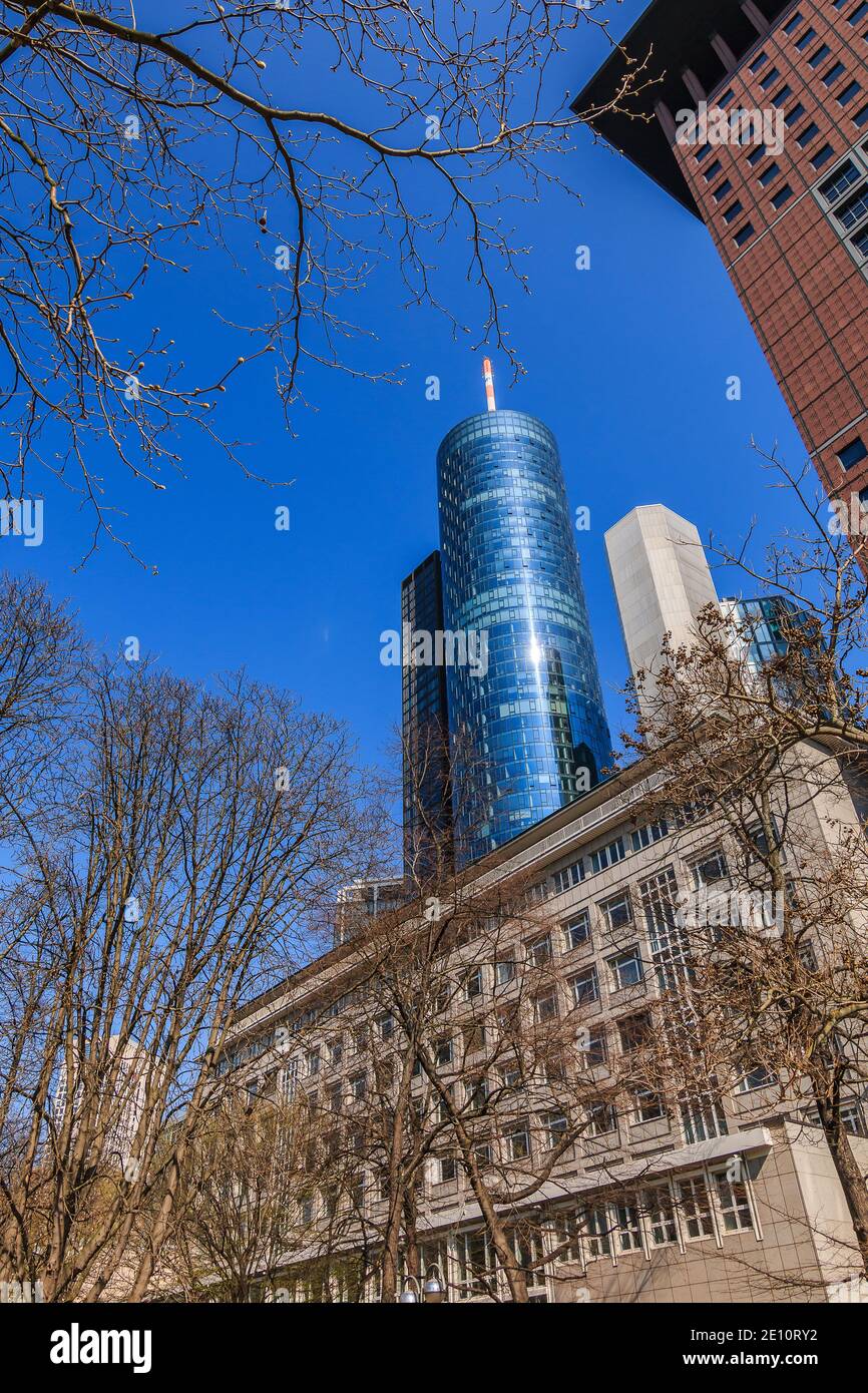Buildings in Frankfurt in the city center. High-rise buildings in the financial and business district. Barren trees without leaves in the foreground w Stock Photo
