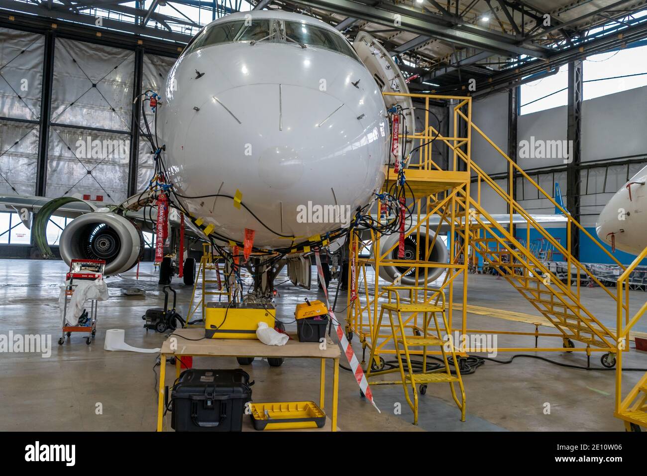 Ukraine, Kyiv - November 25, 2020: The Embraer E190LR UR-EMD aircraft is in the hangar for technical repair and maintenance. Aircraft diagnostics, sto Stock Photo