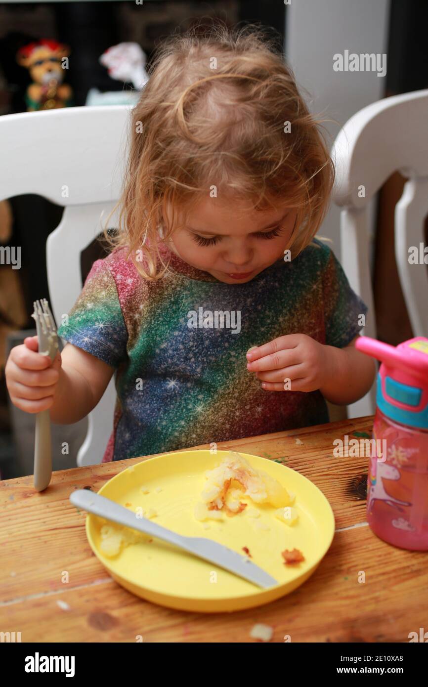 A toddler finishing her dinner, UK Stock Photo Alamy