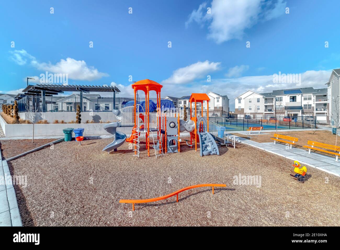 Fun childrens playground and tennis courts at a sunny neighborhood park
