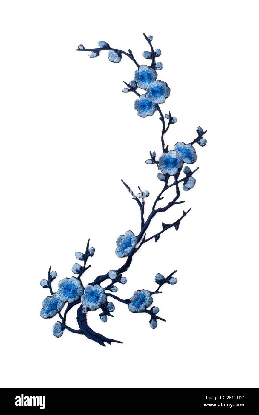 Embroidered branch with blue flowers applique isolated on white ...