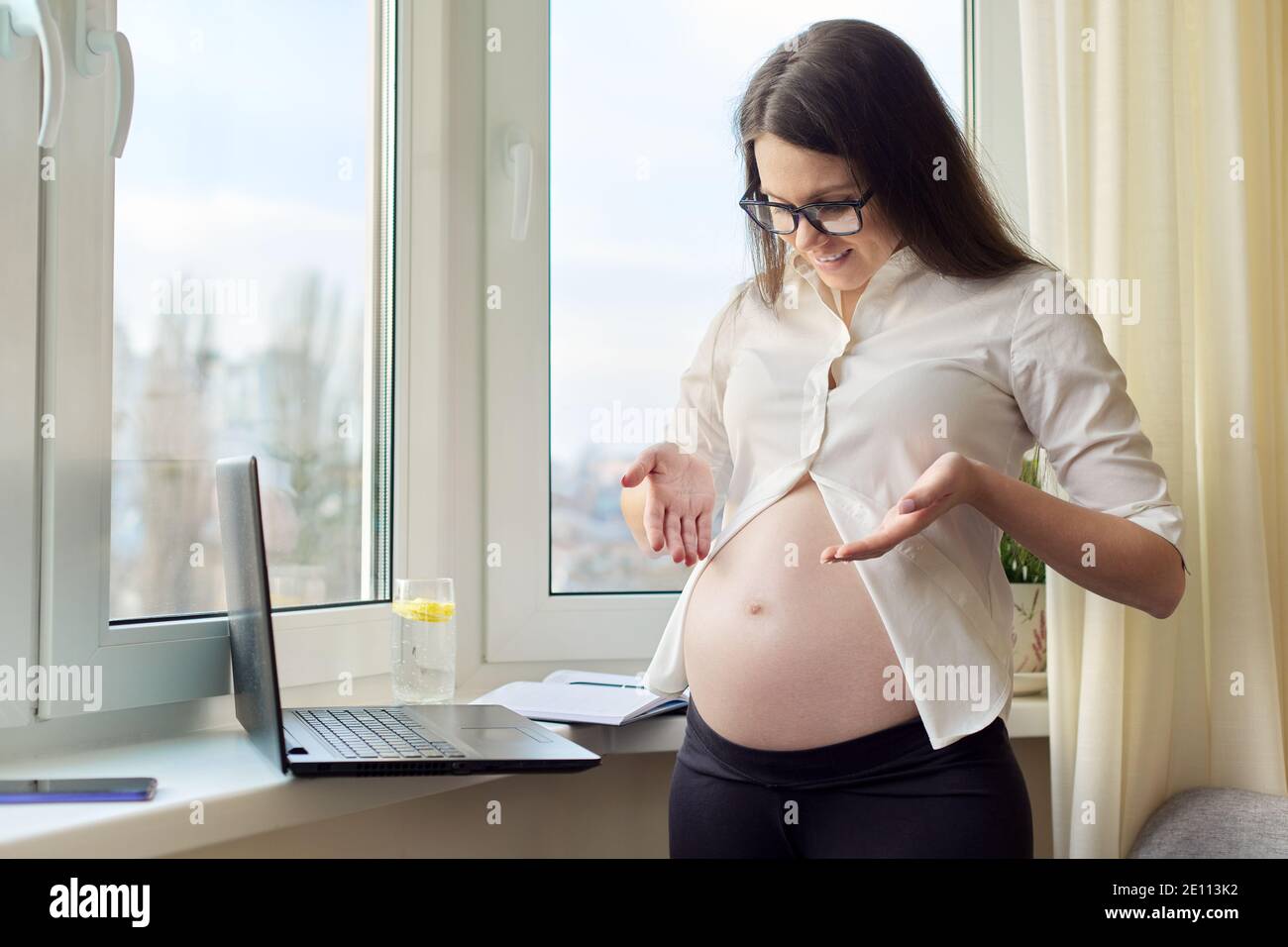 Video chat, call, pregnant happy woman showing big belly in laptop webcam  Stock Photo - Alamy