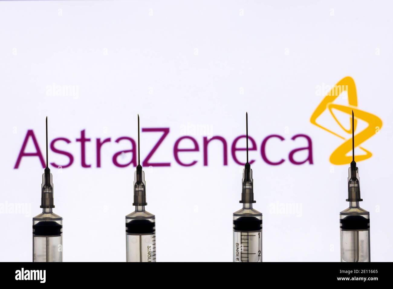 Kathmandu, Nepal - January 03 2021: Closeup of a syringe against Astrazeneca logo Stock Photo