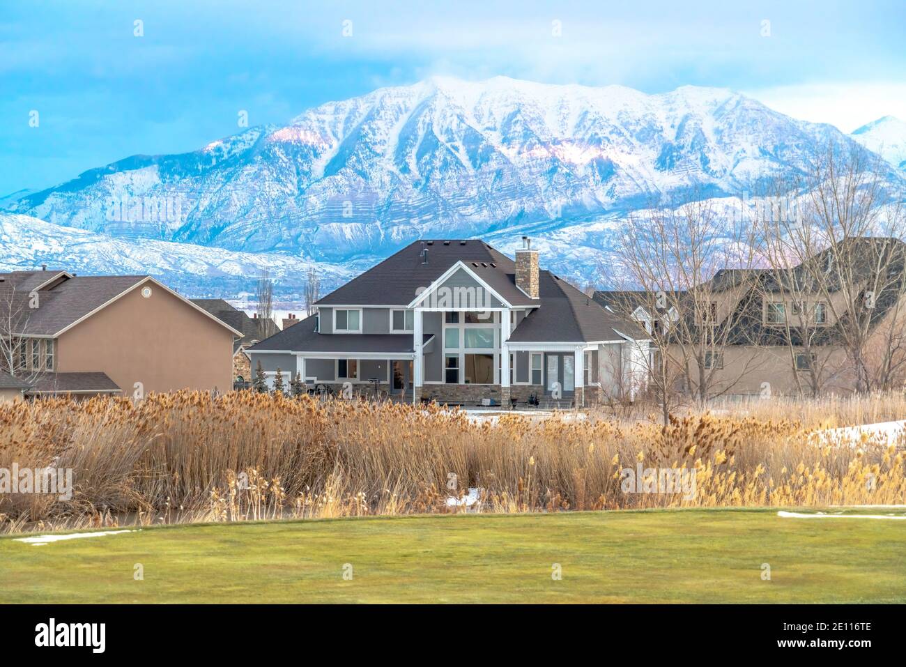 Houses in the snowy valley with overcast sky and picturesque mountain ...