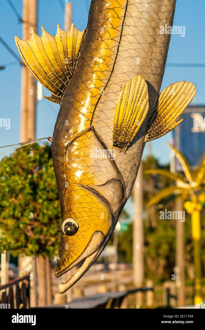 Metal sculpture of a bone fish hangs outside a store on Key Largo in