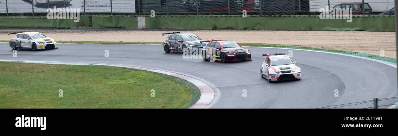 Group of racing touring cars action challenging during the race at turn Stock Photo