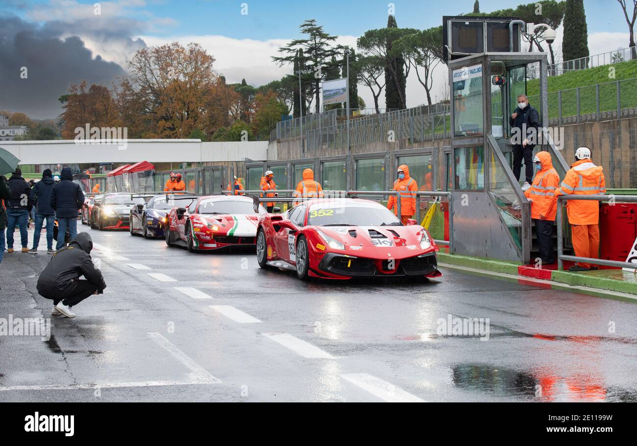 Ferrari supercar 488 gran turismo racing motorsport cars standing in circuit pit lane track waiting for strart on wet asphalt Stock Photo