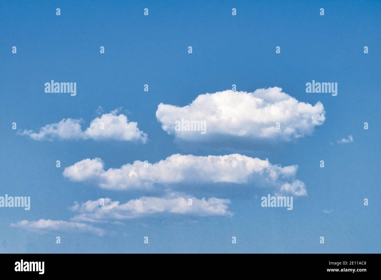 White fluffy clouds in the blue sky. Blue summer sky with white cumulus ...