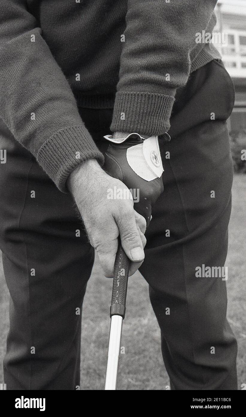 1970s, historical, a close-up photo of a golfer using the 'Vardon grip', also known as the overlapping grip, the position of the hands on a golf club for swinging a golf club properly. The grip was named after lengendary golfer Harry Vardon, a six-time Open Champion. Although the overlap grip is more commony used by golfers, the other grip used is the interlocking grip, which Jack Nicklaus and Tiger Woods, two of the greatest golfers in history both used. Stock Photo