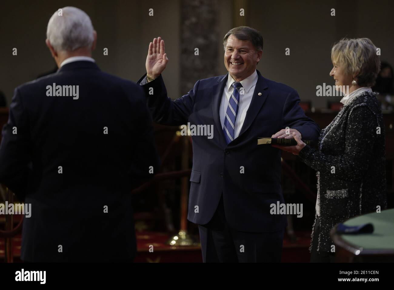 Washington, United States. 03rd Jan, 2021. Senator Mike Rounds, a Republican from South Dakota, center, smiles while being ceremoniously sworn-in by U.S. Vice President Mike Pence, left, at the U.S. Capitol in Washington, DC on Sunday, January 3, 2021. The 117th Congress begins today with the election of the speaker of the House and administration of the oath of office for lawmakers in both chambers, procedures that will be modified to account for Covid-19 precautions. Pool photo Samuel Corum/UPI Credit: UPI/Alamy Live News Stock Photo