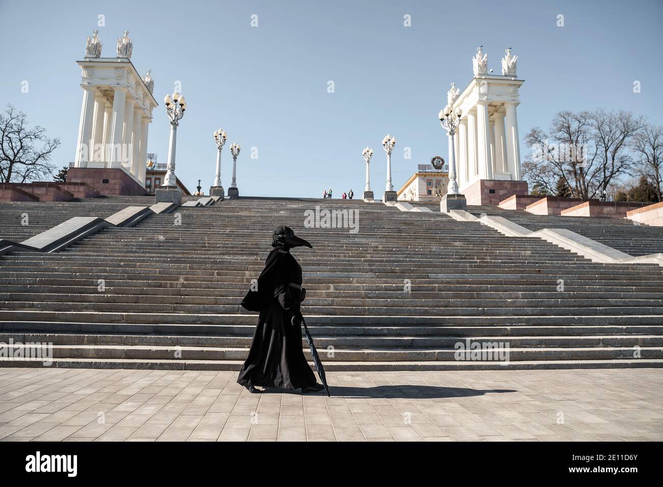 plague doctor in front of the stairs to the top Stock Photo