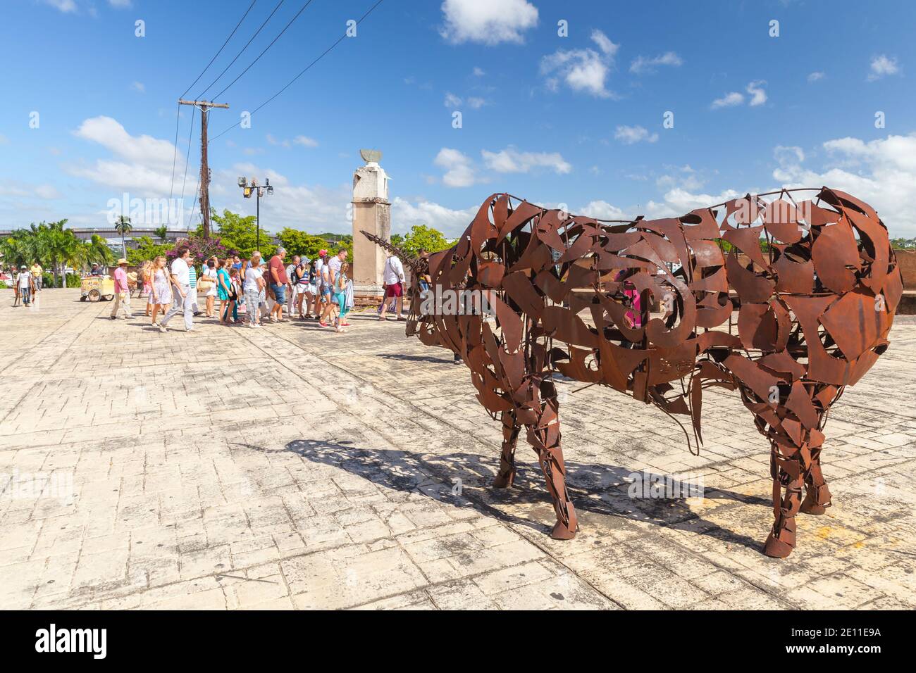 Santo Domingo,  Dominican Republic - January 11, 2017: Tourists walks near rusty bull statue at the Museum of the Royal Houses, Zona Colonial, Distrit Stock Photo