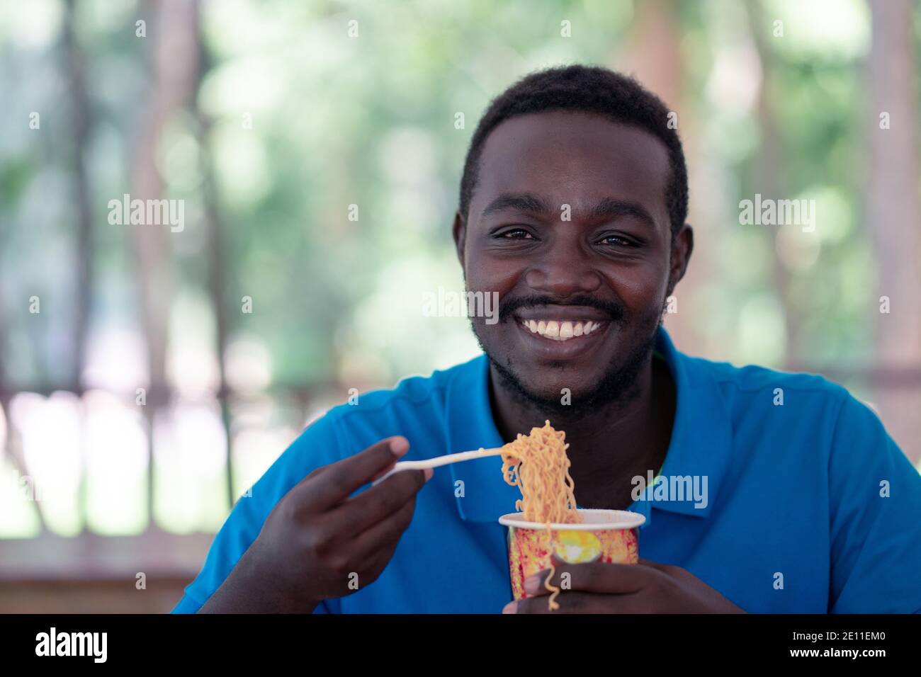 African man eating instant noodle soup Stock Photo Alamy