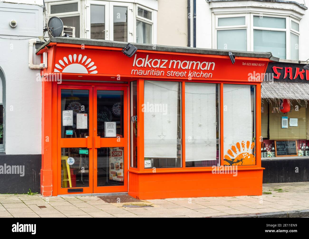 The orange red front facade of Lakaz Maman - a Mauritian street food restaurant owned by Shelina Permalloo in Bedford Place, Southampton, England, UK Stock Photo