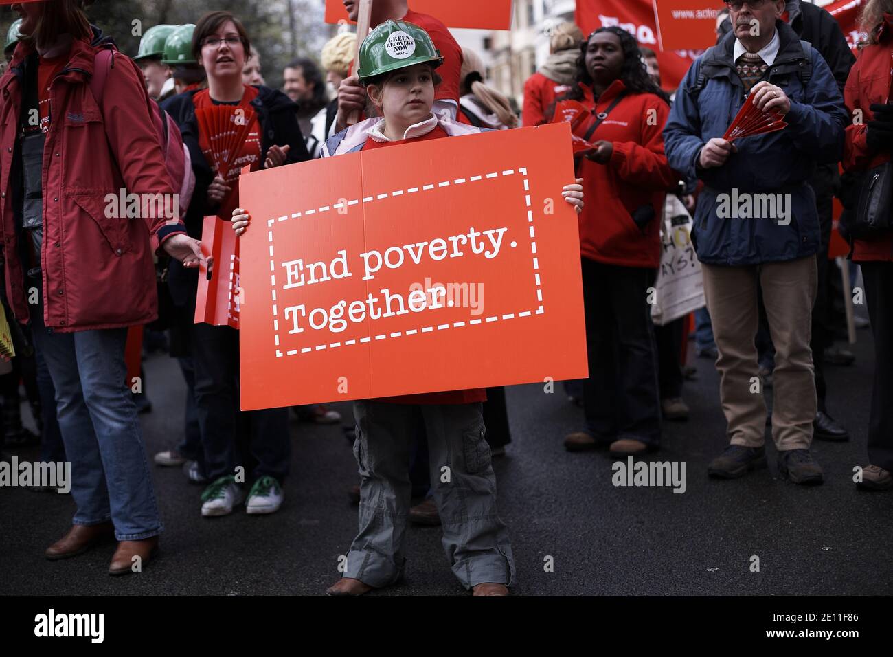 GREAT BRITAIN / England / London /Child  holds a sing  End poverty together 'on March 28, 2009 in London, England. Stock Photo