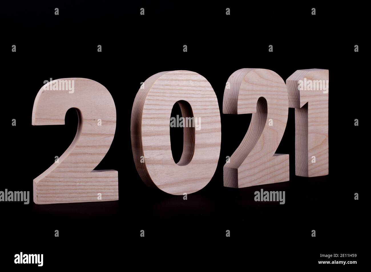 2021 year large wooden numbers at an angle. Hardwood characters on a ...