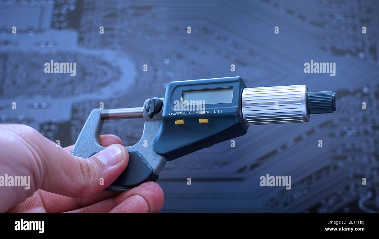 Еnegineer working with a precise micrometer with digital display for quality control. Close up horizontal video of the accurate measuring instrument. Stock Photo