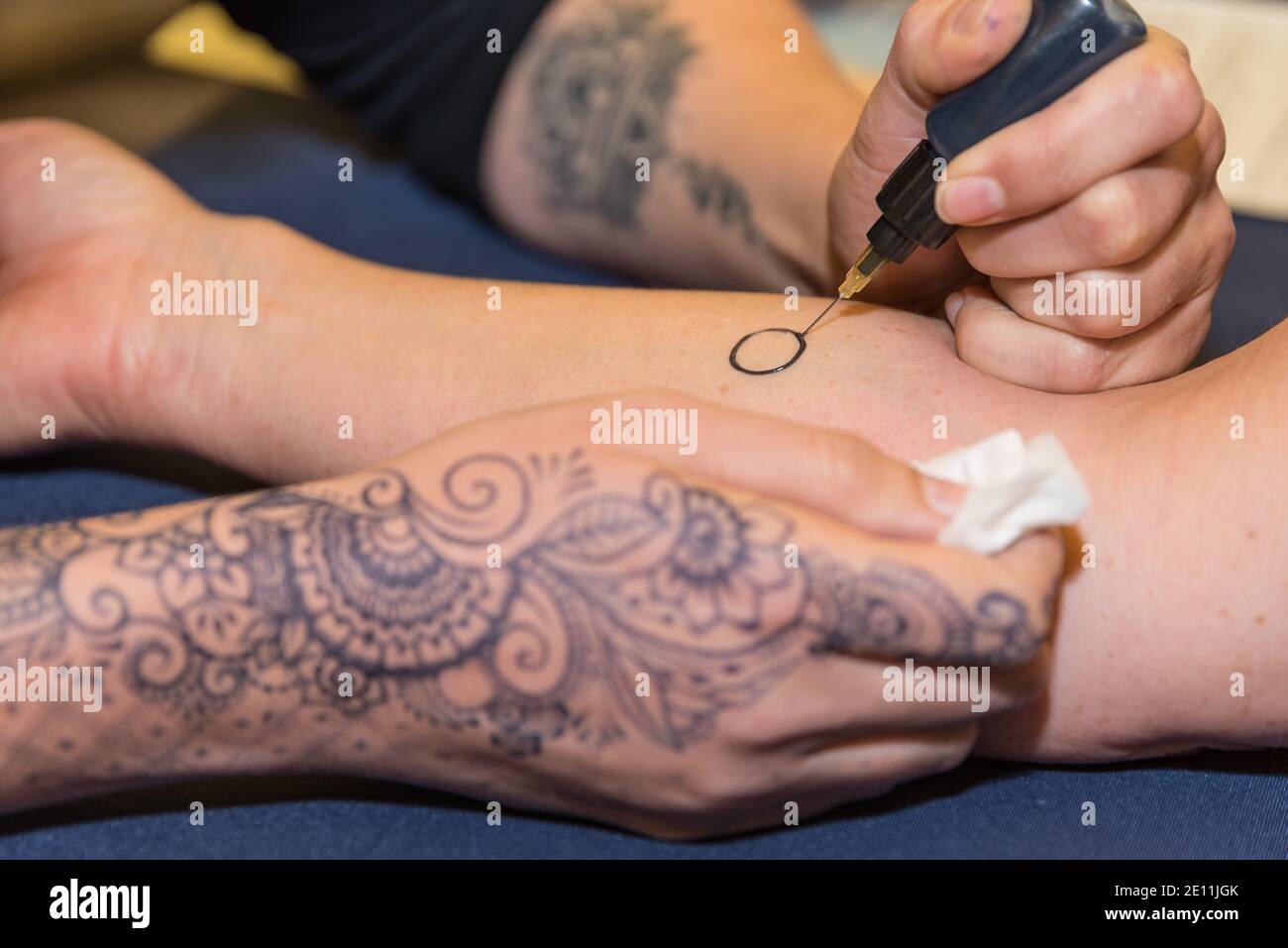 Person Makes Henna Tattoo On His Arm - Mehndi Stock Photo