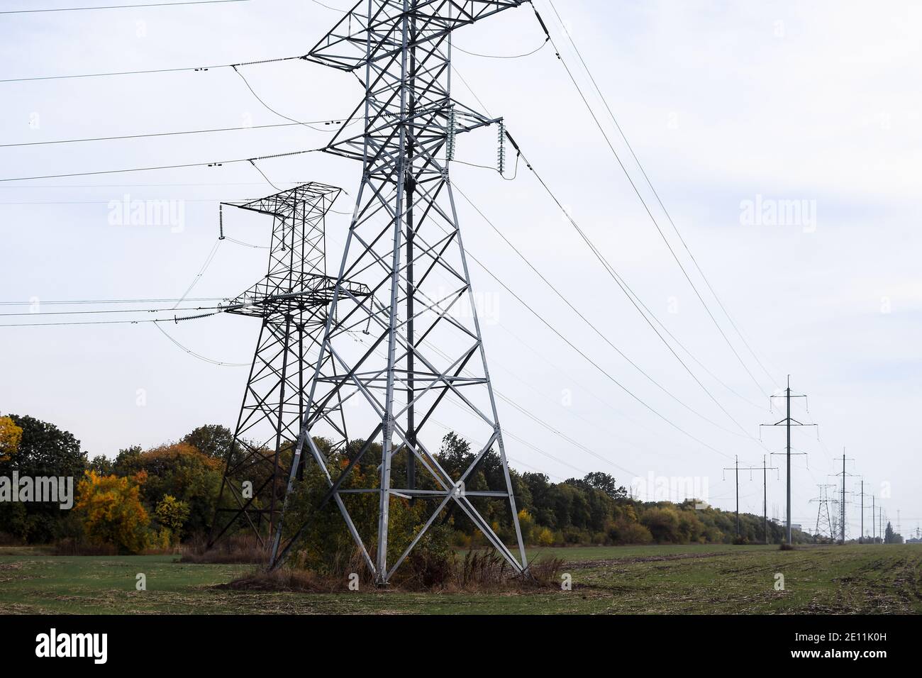 High voltage transmission line. High voltage power tower and nature landscape at day. Stock Photo