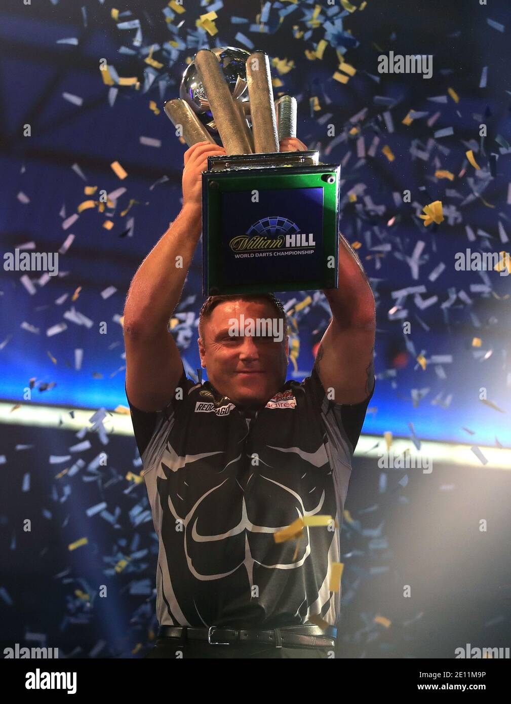 Gerwyn Price lifts the trophy after winning the William Hill World