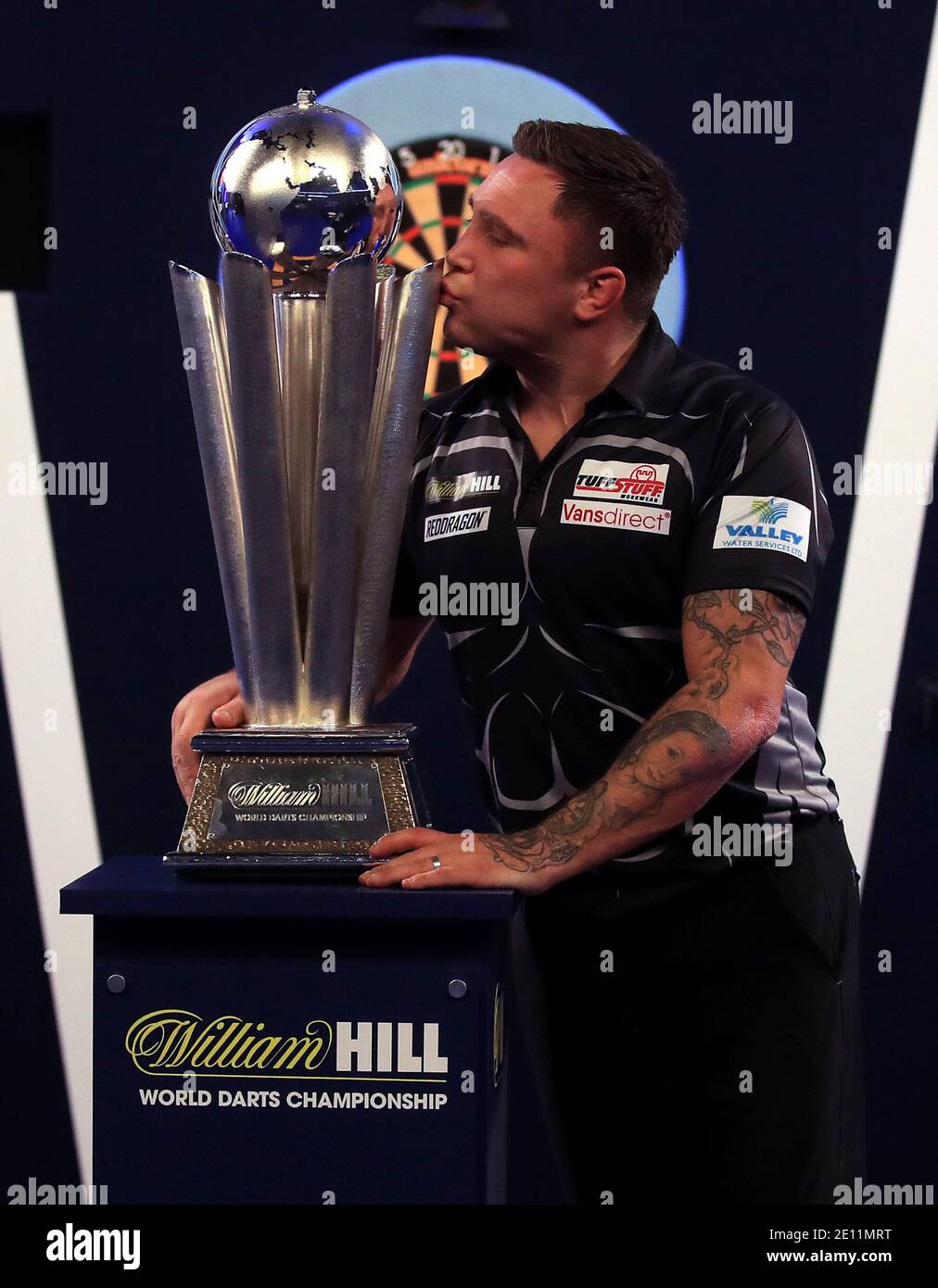 Gerwyn Price kisses the trophy after winning the William Hill World Darts Championship at