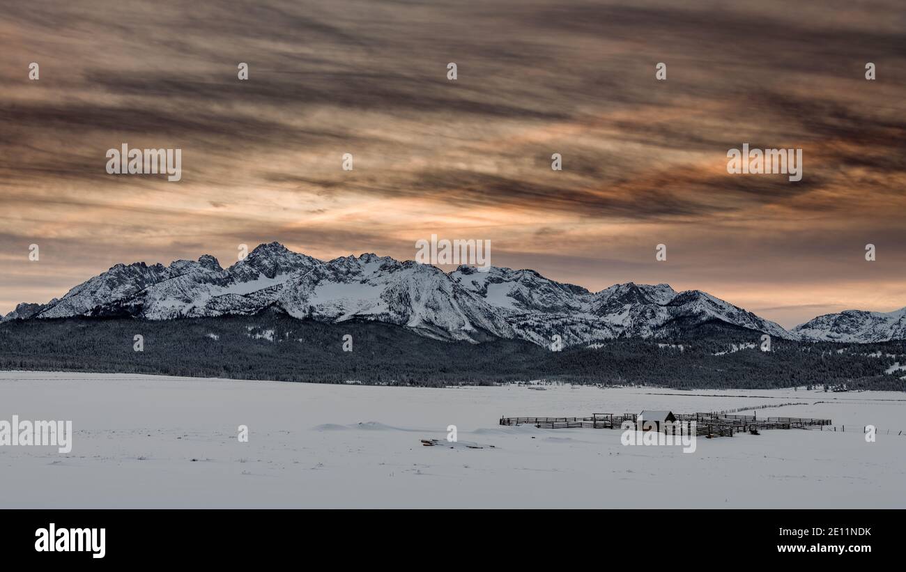 Snow covered field and distant mountain range Stock Photo