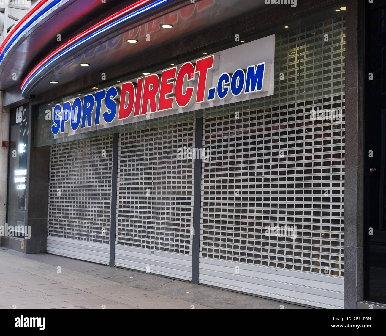 A closed Sports Direct shop on Oxford Street with the shutters