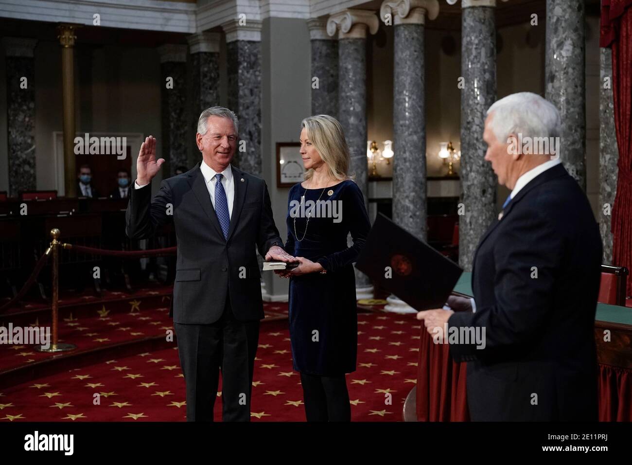 Washington, USA. 03rd Jan, 2021. Sen. Tommy Tuberville, R-Ala., the former Auburn University football coach, is joined by his wife Suzanne Tuberville, as he takes the oath of office from Vice President Mike Pence during a reenactment ceremony in the Old Senate Chamber at the Capitol in Washington, Sunday, Jan. 3, 2021. (Photo by J. Scott Applewhite/Pool/Sipa USA) Credit: Sipa USA/Alamy Live News Stock Photo