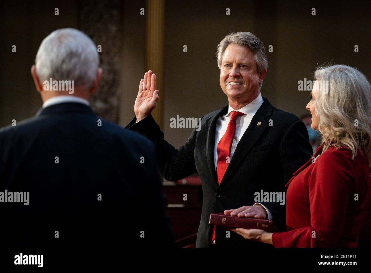 Washington, USA. 03rd Jan, 2021. Vice President Mike Pence administers the Senate oath of office to Roger Marshall (R-KS) as his wife, Laina, holds the bible during a mock swearing-in ceremony in the Old Senate Chamber on Capitol Hill on January 3, 2021 in Washington, DC. (Photo by Pete Marovich/Pool/Sipa USA) Credit: Sipa USA/Alamy Live News Stock Photo