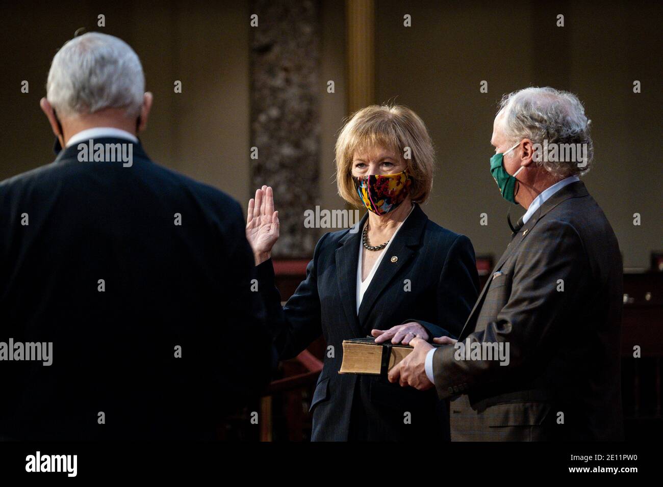 Washington, USA. 03rd Jan, 2021. Vice President Mike Pence administers the Senate oath of office to Senator Tina Smith (D-MN) as her husband, Archie, holds the bible, during a mock swearing-in ceremony in the Old Senate Chamber on Capitol Hill on January 3, 2021 in Washington, DC. (Photo by Pete Marovich/Pool/Sipa USA) Credit: Sipa USA/Alamy Live News Stock Photo