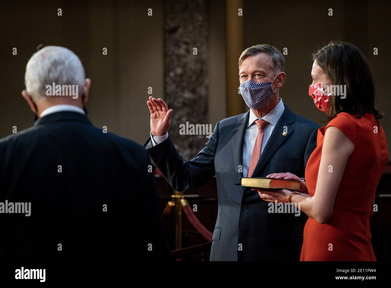 Washington, USA. 03rd Jan, 2021. Vice President Mike Pence administers the Senate oath of office to John Hickenlooper (D-CO) as his wife, Robin Pringle, holds the bible during a mock swearing-in ceremony in the Old Senate Chamber on Capitol Hill on January 3, 2021 in Washington, DC. (Photo by Pete Marovich/Pool/Sipa USA) Credit: Sipa USA/Alamy Live News Stock Photo
